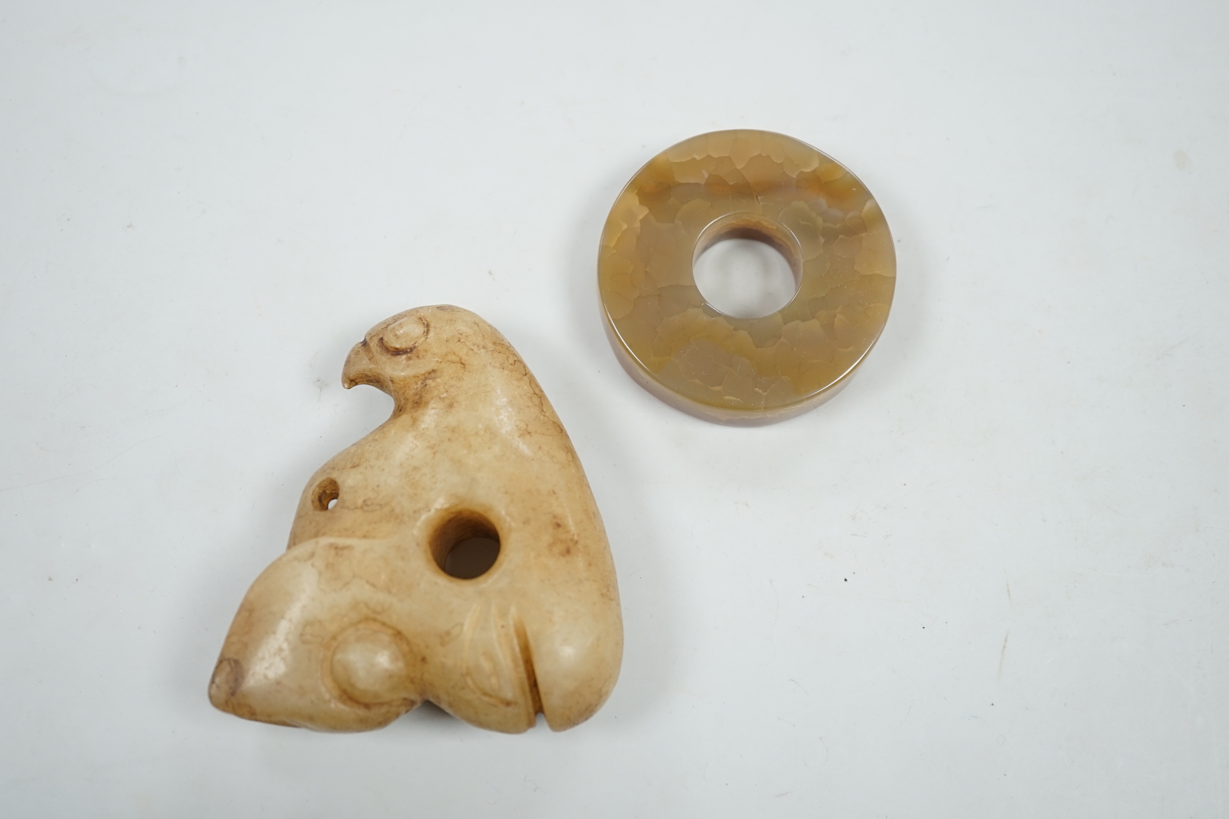 A Chinese agate bi disc and an archaistic jade eagle, 8.5cm